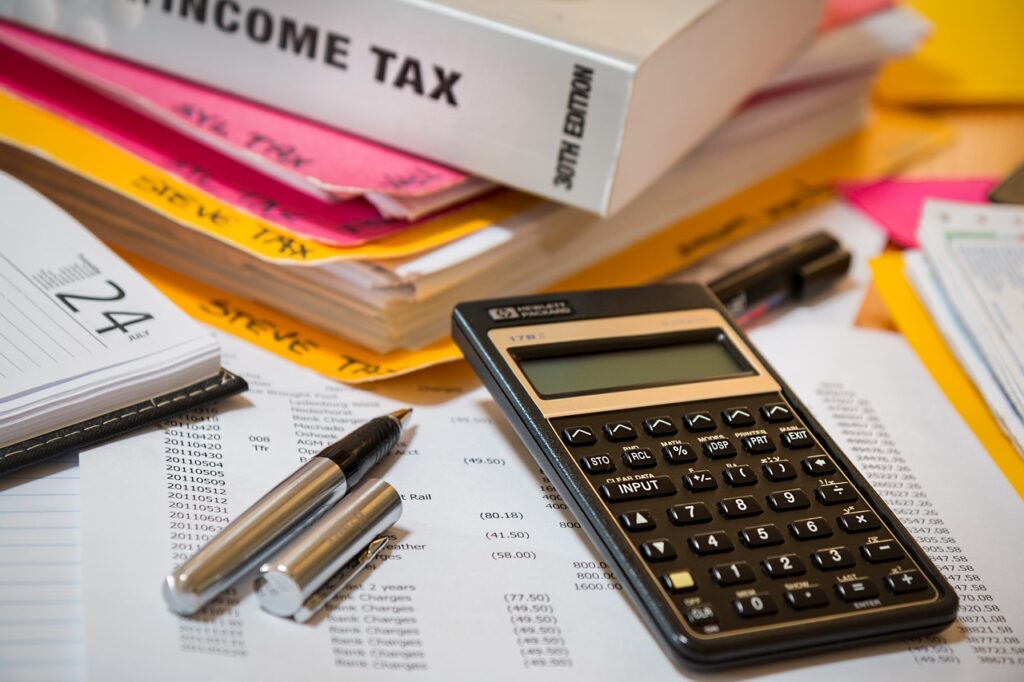 Calculator, papers and pen on the table