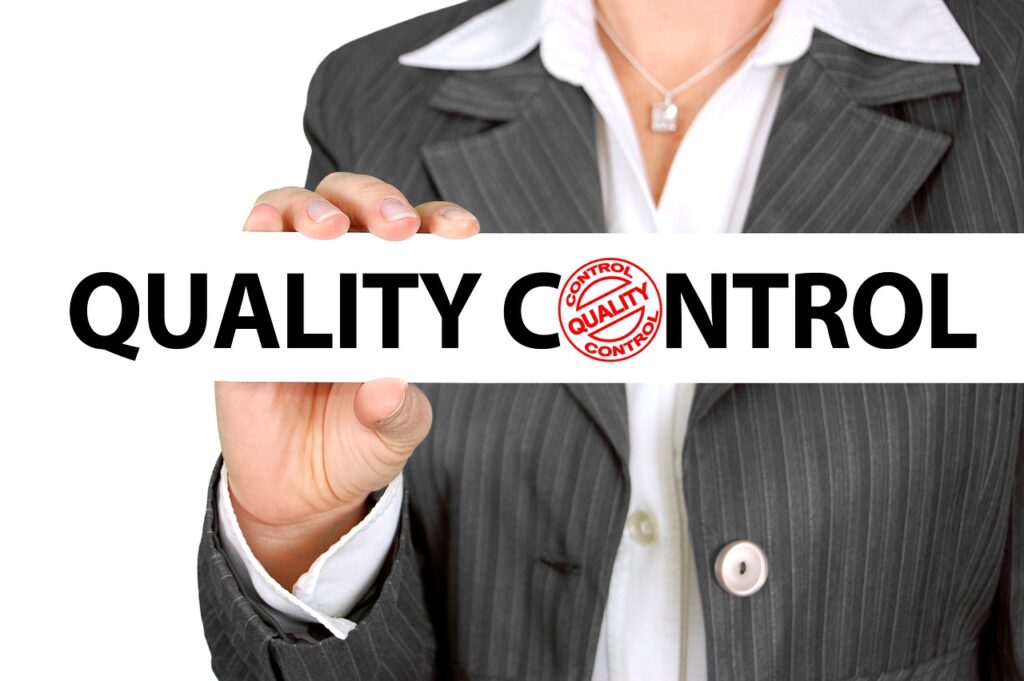 Business Woman holding a Quality Control Sign