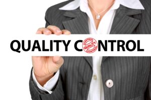 Business Woman holding a Quality Control Sign